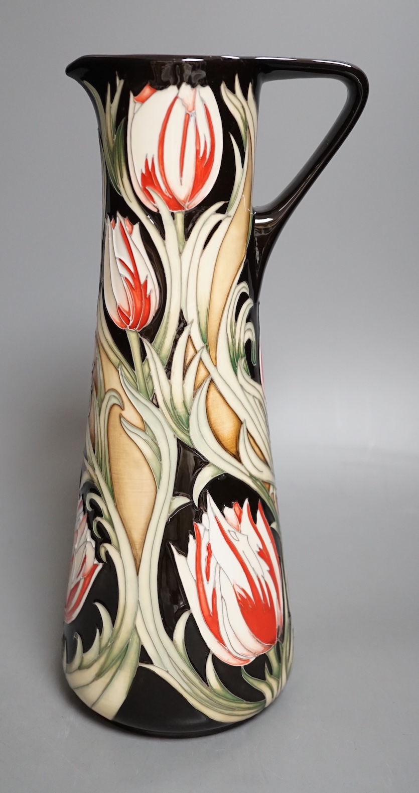 A Moorcroft 'race against time' jug by Paul Hilditch, limited edition 11/40, boxed, 31 cms high.
